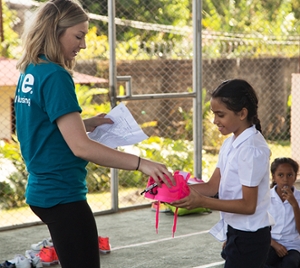 SIUE nursing student gives shoes to Costa Rican girl. 